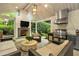 Cozy covered outdoor living area features a fireplace, tv, kitchen and comfortable seating at 2562 Red Valley Rd, Atlanta, GA 30305