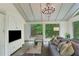 Relaxing sunroom featuring built in cabinets, a chandelier, and large windows at 2562 Red Valley Rd, Atlanta, GA 30305