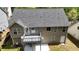 This home has a spacious back exterior with a deck, patio, and manicured lawn at 4175 Round Stone Dr, Snellville, GA 30039