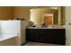 Chic bathroom with dark vanity, ample counter space, and a modern tile backsplash at 4175 Round Stone Dr, Snellville, GA 30039