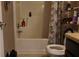 Standard bathroom with tub, shower, and vanity with a black cabinet at 4175 Round Stone Dr, Snellville, GA 30039
