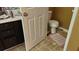 Modest bathroom featuring a toilet, and vanity with a dark brown cabinet at 4175 Round Stone Dr, Snellville, GA 30039
