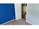 This is a closet with paintings on the floor and a blue accent wall to the left of the door at 4175 Round Stone Dr, Snellville, GA 30039