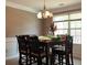 Dining room with large window for natural light and wood table set and chairs at 4175 Round Stone Dr, Snellville, GA 30039