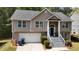 Charming two-story home with a well-manicured lawn and a welcoming front porch with gray-painted stairs at 4175 Round Stone Dr, Snellville, GA 30039