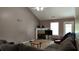 Cozy living room featuring hardwood floors, high ceiling, and a fireplace at 4175 Round Stone Dr, Snellville, GA 30039