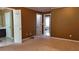 Cozy main bedroom featuring warm-toned walls, soft carpet and multiple entryways to other parts of the home at 4175 Round Stone Dr, Snellville, GA 30039