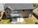 Aerial view of the home's rear exterior, featuring a deck, patio, and landscaped yard at 4175 Round Stone Dr, Snellville, GA 30039