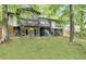 Two-story home with a deck and porch offering stunning views of the private, tree-lined backyard at 230 Summerfield Dr, Alpharetta, GA 30022