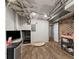 Finished basement with wood flooring, exposed ducts, brick walls, and space for recreation and storage at 230 Summerfield Dr, Alpharetta, GA 30022