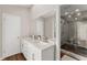 Modern bathroom with double vanity, marble countertops, and a glass-enclosed shower at 230 Summerfield Dr, Alpharetta, GA 30022