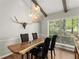 Dining room featuring live edge table, modern lighting, and large windows at 230 Summerfield Dr, Alpharetta, GA 30022