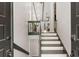 Inviting foyer featuring hardwood stairs, modern railing, and an open floor plan leading to the living area at 230 Summerfield Dr, Alpharetta, GA 30022