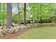 Beautiful front yard with mature trees and landscaping at 230 Summerfield Dr, Alpharetta, GA 30022