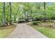 Long driveway leading to the front exterior of the home surrounded by mature trees at 230 Summerfield Dr, Alpharetta, GA 30022
