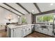 Bright kitchen with vaulted ceilings, wood beams, large island, and stainless steel appliances at 230 Summerfield Dr, Alpharetta, GA 30022