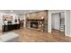 Cozy living room features a brick fireplace, wood floors, and space for a home office setup at 230 Summerfield Dr, Alpharetta, GA 30022