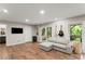 Living room featuring recessed lighting, wood flooring and a stylish gray sofa with a chaise lounge at 230 Summerfield Dr, Alpharetta, GA 30022