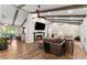 Open living room with wood beams, fireplace, and view of the kitchen and backyard at 230 Summerfield Dr, Alpharetta, GA 30022