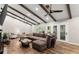 Spacious living room boasts vaulted ceilings with wood beams and a large sectional couch at 230 Summerfield Dr, Alpharetta, GA 30022
