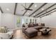 Spacious living room with vaulted ceilings, exposed beams, and access to the outdoor patio at 230 Summerfield Dr, Alpharetta, GA 30022