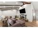 Cozy living room featuring a fireplace, exposed beams, and ample seating space at 230 Summerfield Dr, Alpharetta, GA 30022