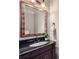 Bathroom featuring black vanity, black countertop, decorative framed mirror and modern fixtures at 2700 Pine Tree Ne Rd # 4003, Atlanta, GA 30324