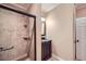 Bathroom featuring a tiled shower, dark vanity, decorative mirror and modern fixtures at 2700 Pine Tree Ne Rd # 4003, Atlanta, GA 30324