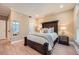 Bedroom featuring a bed with decorative headboard, bedside tables with lamps, and a window at 2700 Pine Tree Ne Rd # 4003, Atlanta, GA 30324