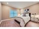 Bedroom featuring a comfortable bed, bedside tables with lamps, and a large window at 2700 Pine Tree Ne Rd # 4003, Atlanta, GA 30324