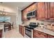 Well-equipped kitchen with wooden cabinets, granite countertops, and modern appliances at 2700 Pine Tree Ne Rd # 4003, Atlanta, GA 30324