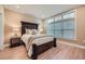 Bedroom featuring a comfortable bed, bedside tables with lamps, and a large window at 2700 Pine Tree Ne Rd # 4003, Atlanta, GA 30324