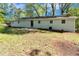 Backyard view of the home showing the home's siding and level yard space at 3795 Willowbrook Dr, Douglasville, GA 30135