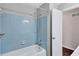 Bathroom with a white shower-tub combination featuring classic blue tiling and chrome fixtures at 3795 Willowbrook Dr, Douglasville, GA 30135
