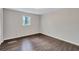 Bedroom featuring a window for natural light and sleek, dark-stained flooring at 3795 Willowbrook Dr, Douglasville, GA 30135