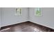 Bedroom with hardwood floors, two windows offering natural light, and neutral paint throughout at 3795 Willowbrook Dr, Douglasville, GA 30135