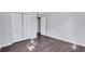 Bedroom featuring wood-look floors, white walls, and a large closet with paneled doors at 3795 Willowbrook Dr, Douglasville, GA 30135