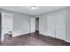 Bedroom featuring wood-look floors and an open doorway to a bathroom with a shower-tub combination at 3795 Willowbrook Dr, Douglasville, GA 30135