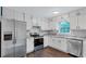 Bright kitchen featuring white cabinets, stainless steel appliances, and modern countertop at 3795 Willowbrook Dr, Douglasville, GA 30135