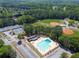 Aerial view of a community's amenities including pool, tennis courts, baseball fields and clubhouse at 503 Madison Se Ct, Smyrna, GA 30080