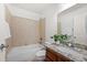 Bathroom featuring granite counters, wood cabinets, and tub with shower at 503 Madison Se Ct, Smyrna, GA 30080