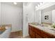 Bathroom featuring granite counters, wood cabinets, and separate tub and shower at 503 Madison Se Ct, Smyrna, GA 30080