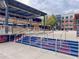 Outdoor area with seating and stairs painted with team colors, near a brick building and partly cloudy sky at 503 Madison Se Ct, Smyrna, GA 30080