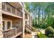 Exterior view of multi-story homes with stone accents and balconies overlooking a wooded area at 503 Madison Se Ct, Smyrna, GA 30080