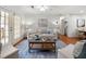 Cozy living room featuring hardwood floors, neutral colors, and french doors to patio at 503 Madison Se Ct, Smyrna, GA 30080