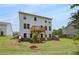 Backyard view showing a large lawn, an elevated wooden deck, and surrounding homes at 540 Teversham Dr, Mcdonough, GA 30253
