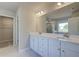 Bright bathroom with double vanity, white cabinets, and a walk-in closet at 540 Teversham Dr, Mcdonough, GA 30253