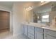 Large bathroom featuring a double vanity with a white countertop, a large mirror, and modern fixtures at 540 Teversham Dr, Mcdonough, GA 30253