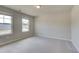 Light-filled bedroom featuring neutral walls, plush carpet, and a large window offering great daylight at 540 Teversham Dr, Mcdonough, GA 30253
