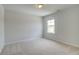 Cozy bedroom with neutral walls, plush carpet, and a bright window providing plenty of natural light at 540 Teversham Dr, Mcdonough, GA 30253